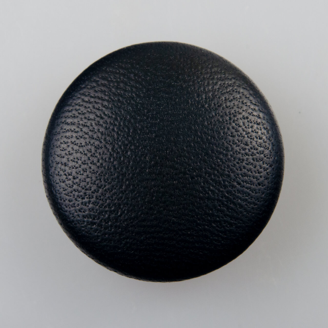 Guzik obciągany naturalną skórą w kolorze czarnym, śr. 25 mm