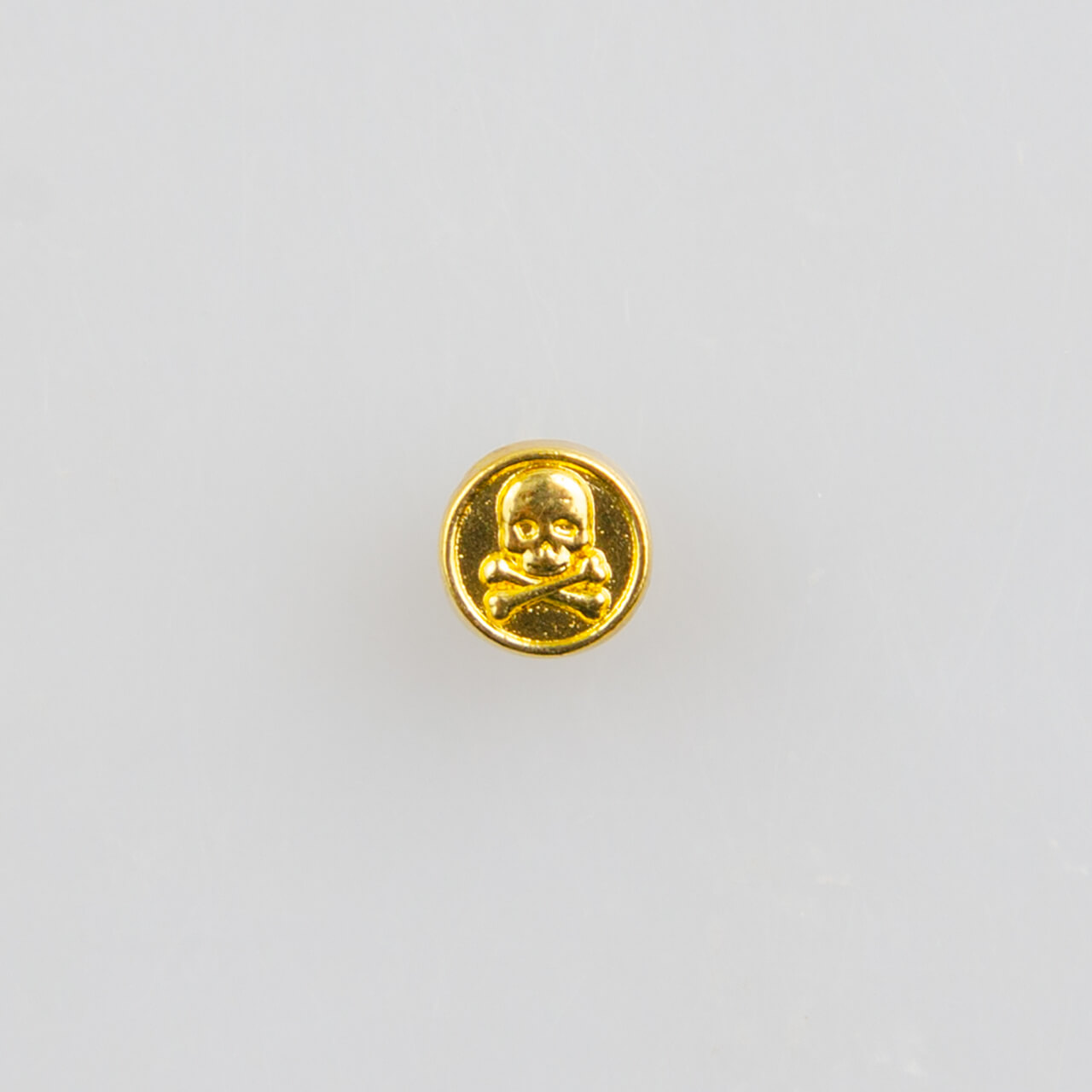 Mini guzik płaski z czaszką i piszczelami, złoty śr. 5 mm